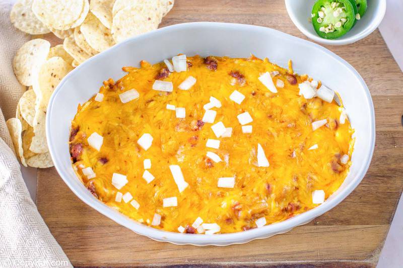 chili cheese dip, tortilla chips, and jalapeno pepper slices