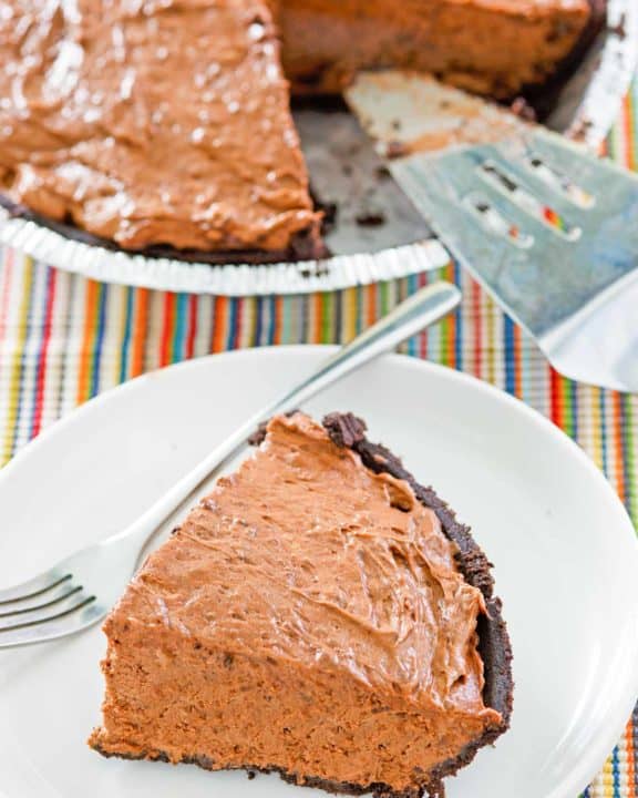 chocolate pudding pie in a pie plate and a slice on a plate