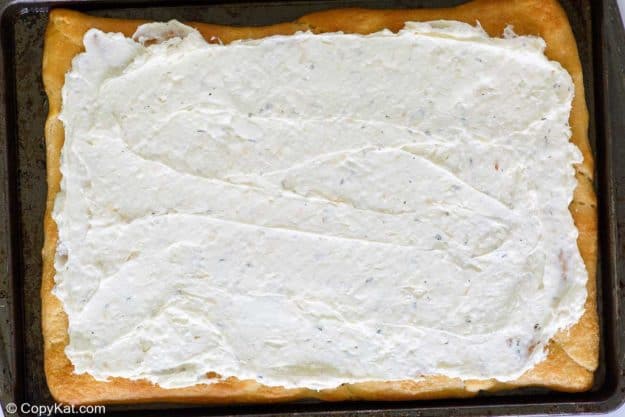 baked crescent roll pizza crust topped with cream cheese mixture