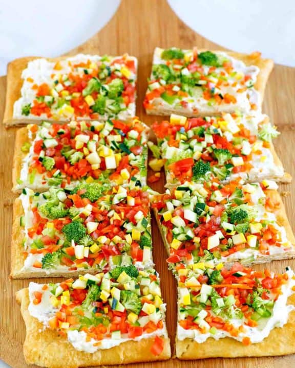 crescent roll veggie pizza on a cutting board