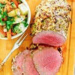 eye of round roast, meat fork, and vegetables