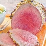 eye of round roast and slices on a cutting board