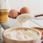 homemade garlic aioli in a bowl and on a spoon
