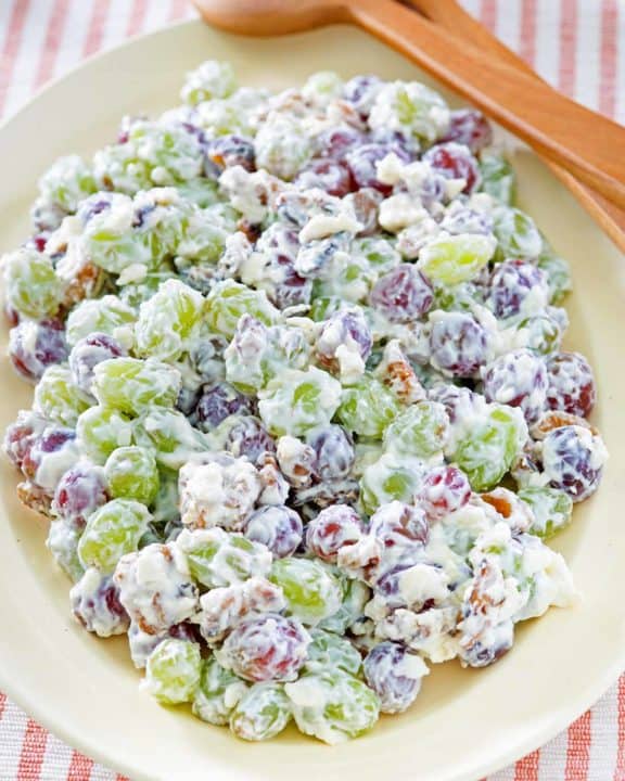 grape salad and salad tongs on a platter