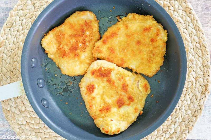 browned panko breaded pork loin cutlets in a skillet