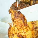 knife slicing smoked beer can chicken
