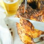 knife cutting into a smoked beer can chicken