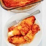 overhead view of sour cream chicken enchiladas on a plate and in a baking dish