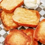 texas toast slices and a bowl of parmesan cheese