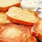slices of texas toast and a bowl of parmesan cheese