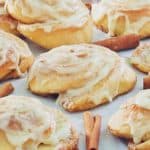 frosted cinnamon rolls and cinnamon sticks