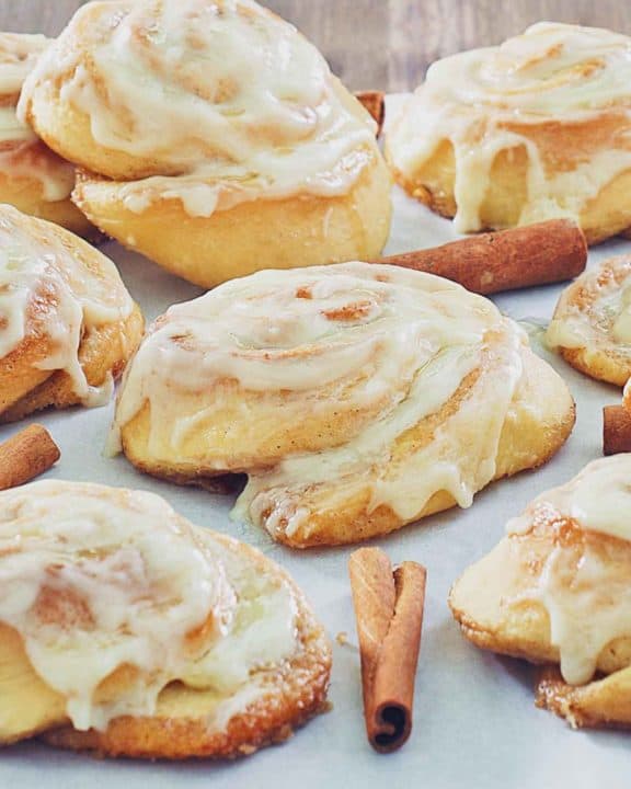 frosted cinnamon rolls and cinnamon sticks