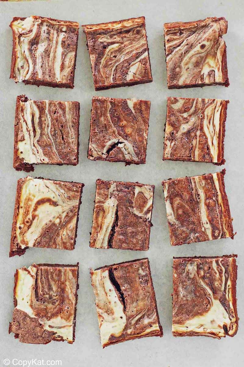 12 cream cheese brownies on parchment paper