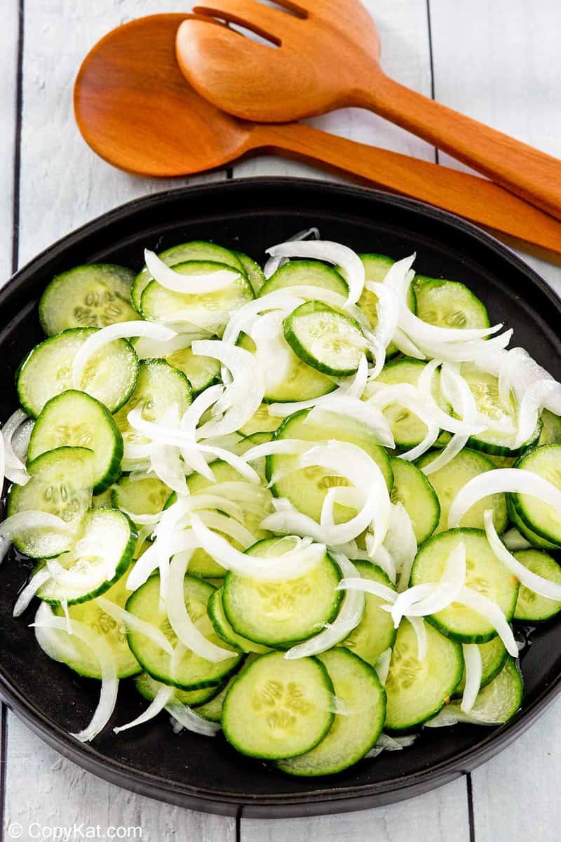cucumber onion salad in a black bowl