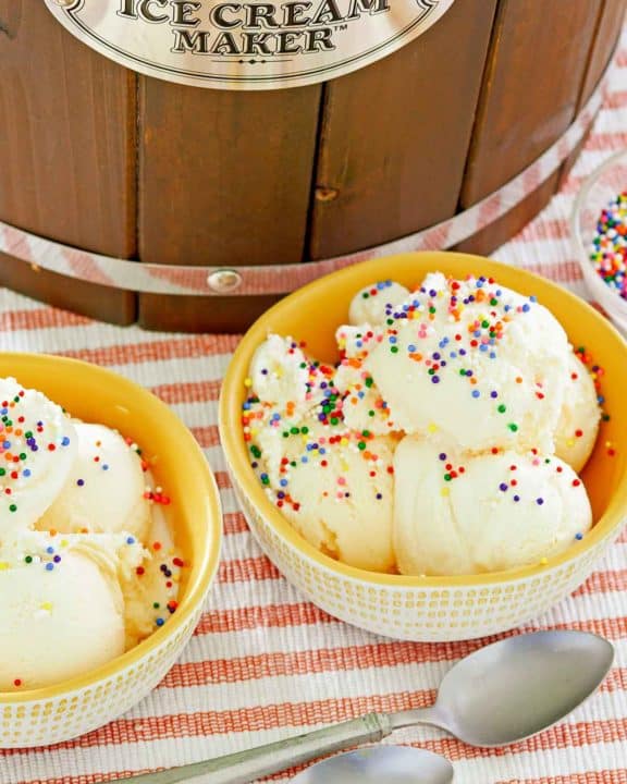 homemade vanilla ice cream, spoons, and ice cream maker