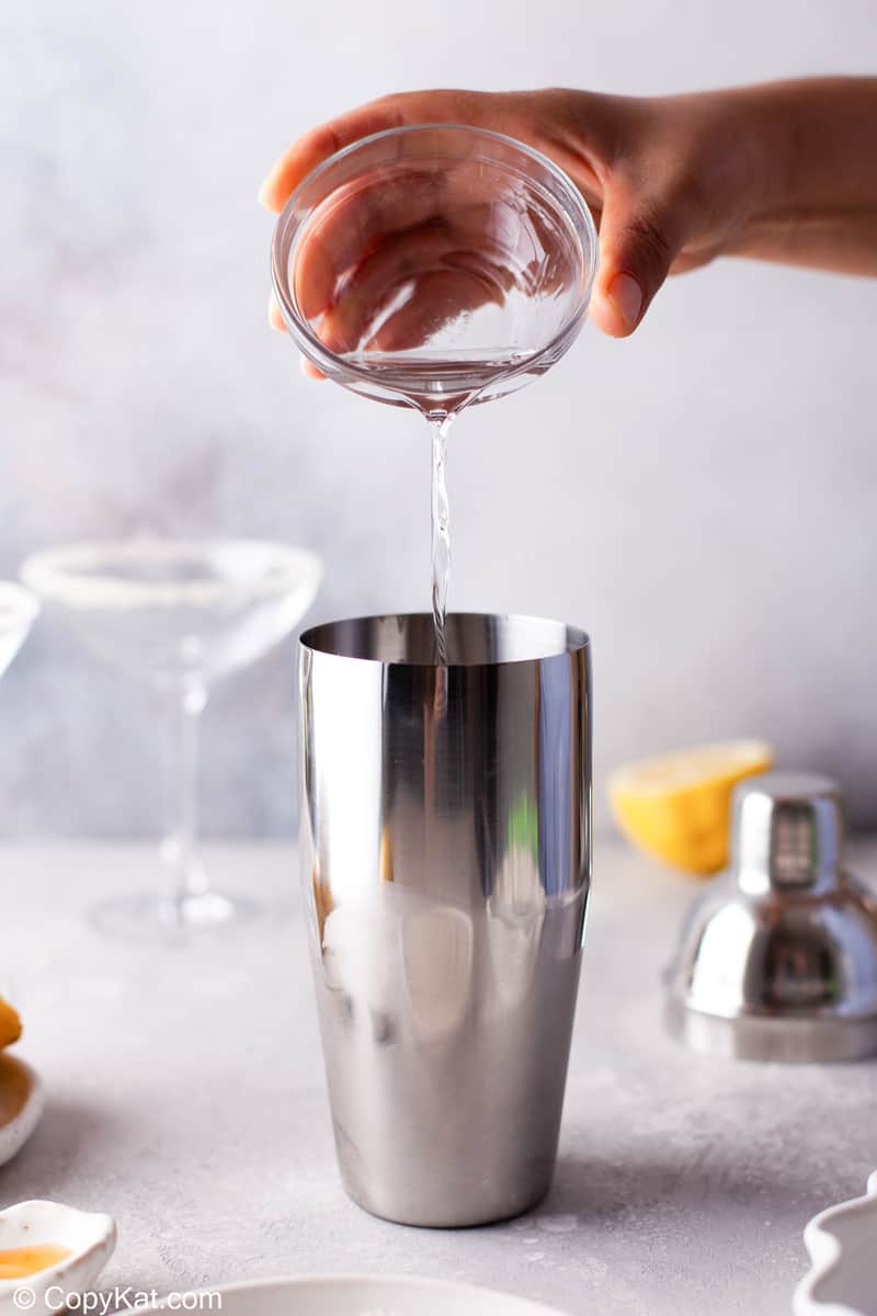 pouring Cointreau in a cocktail shaker