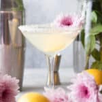 lemon drop martini garnished with a mum flower