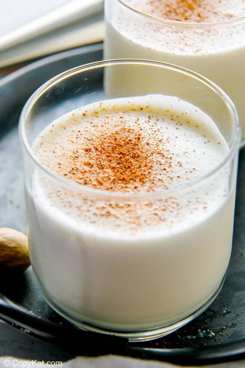 a glass of milk punch topped with nutmeg