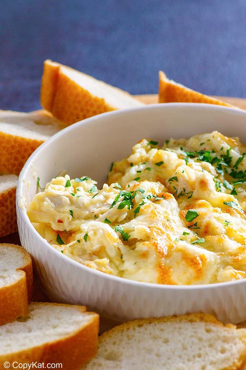 homemade Olive Garden angry alfredo with chicken in a bowl and bread slices