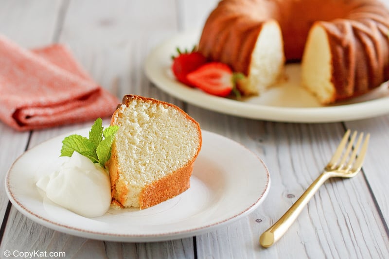 a slice of Scandinavian almond cake and whipped cream on a plate