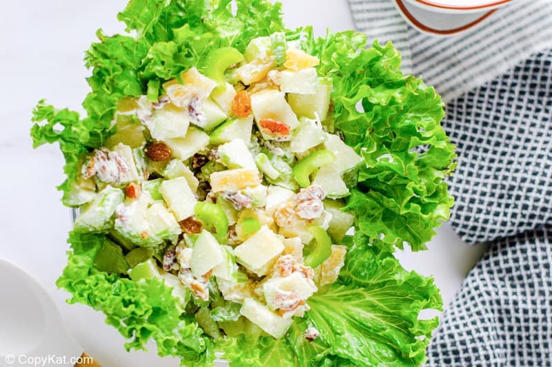 overhead view of Waldorf salad in a lettuce-lined bowl