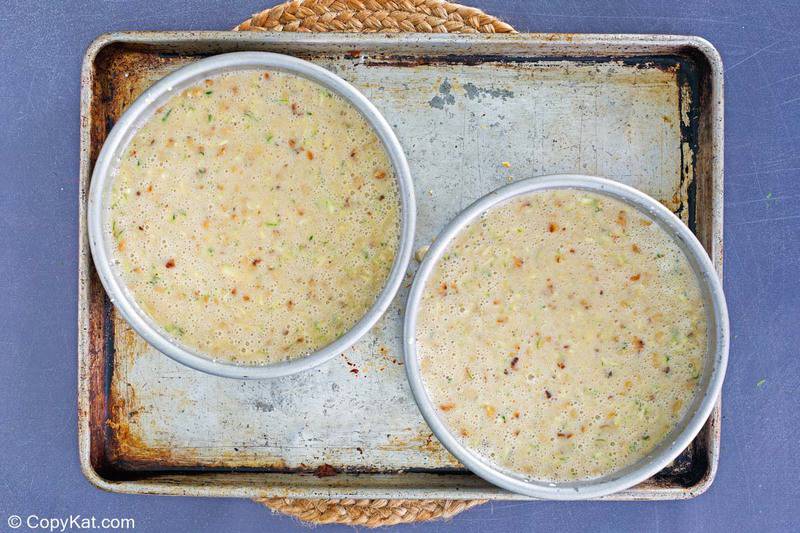 zucchini cake batter in round pans before baking