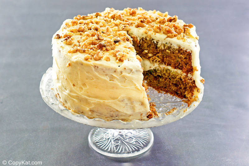 zucchini cake with cream cheese frosting on a stand