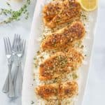 overhead view of lemon pepper chicken and rice on a platter.