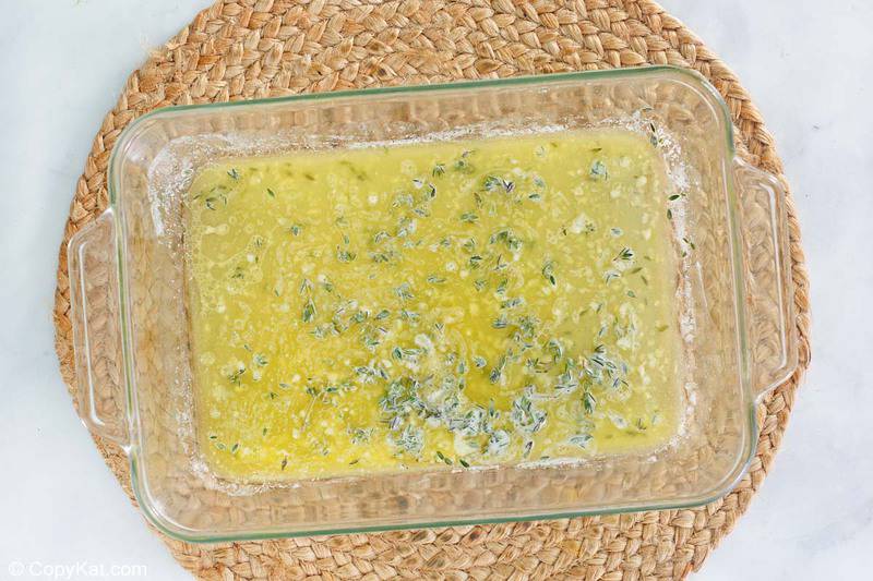 melted butter, garlic, thyme, and lemon juice in a baking dish.