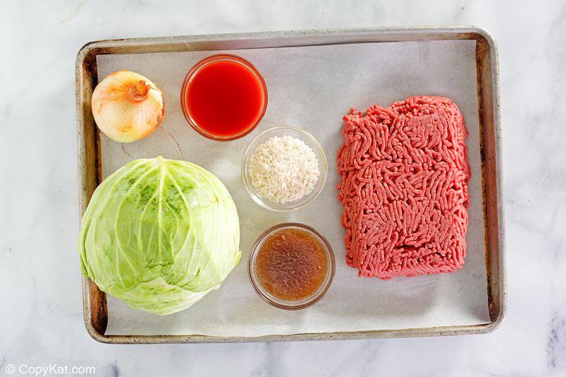 cabbage roll casserole ingredients on a baking sheet.