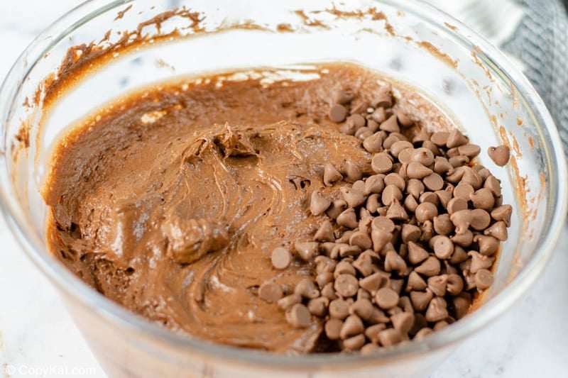 adding chocolate chips to chocolate bundt cake batter.