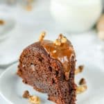 a slice of glazed chocolate bundt cake on a plate
