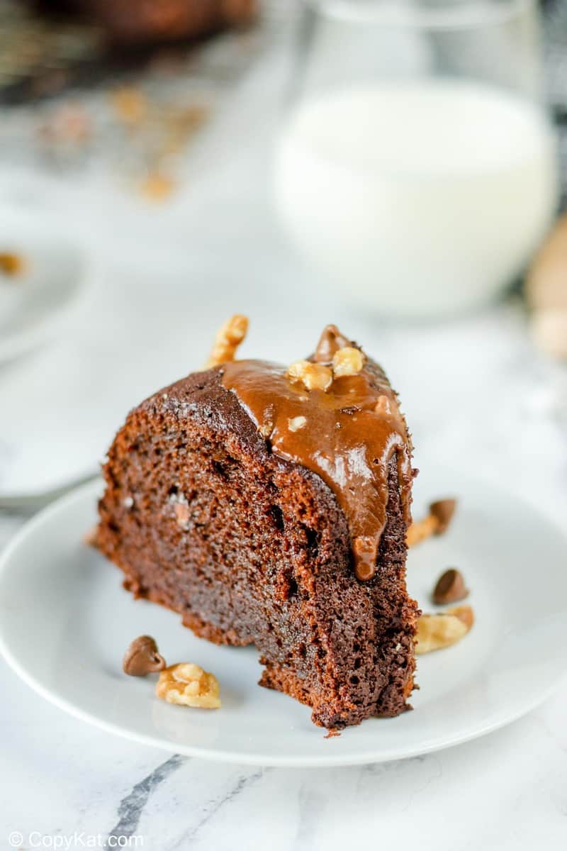 a slice of glazed chocolate bundt cake on a plate
