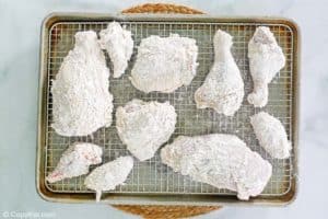 breaded chicken pieces on a wire rack.