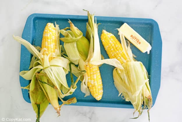 grilled corn on the cob ingredients on a tray.