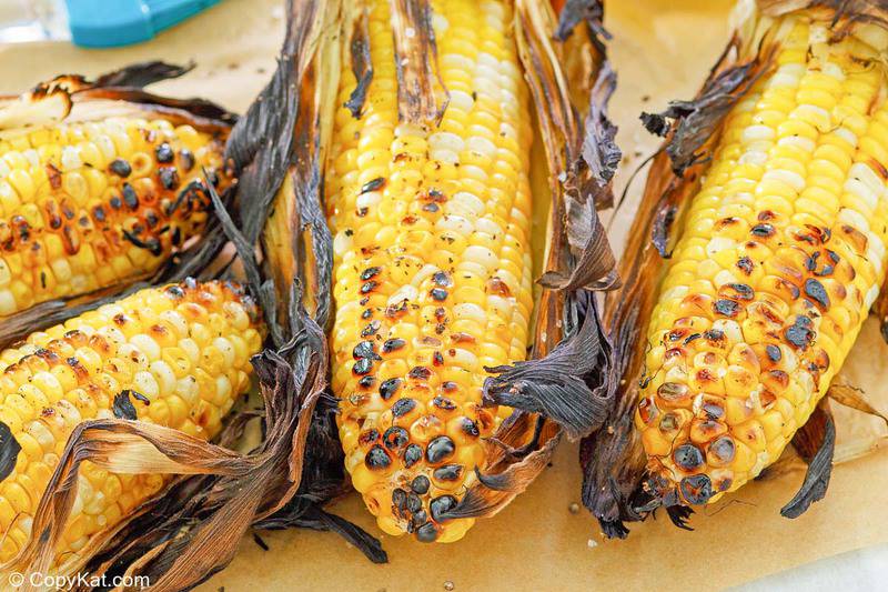 grilled corn on the cob with husks.