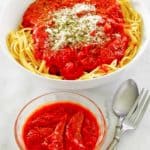 homemade spaghetti sauce in a bowl and on top of spaghetti pasta.