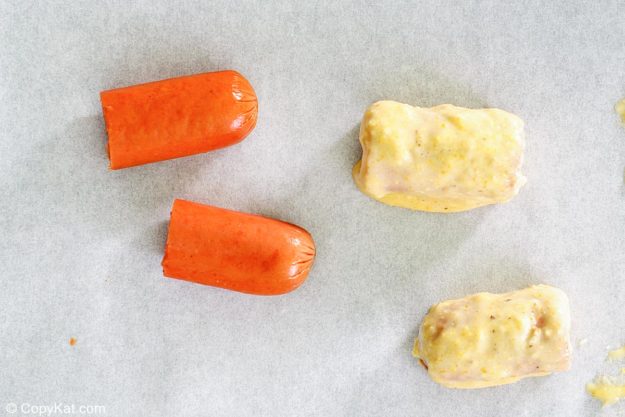 hot dogs cut and dipped in cornmeal batter.