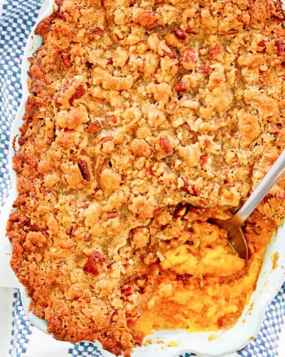 overhead view of sweet potato souffle with pecans in a baking dish.