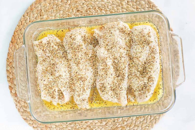 lemon pepper chicken in a dish before baking