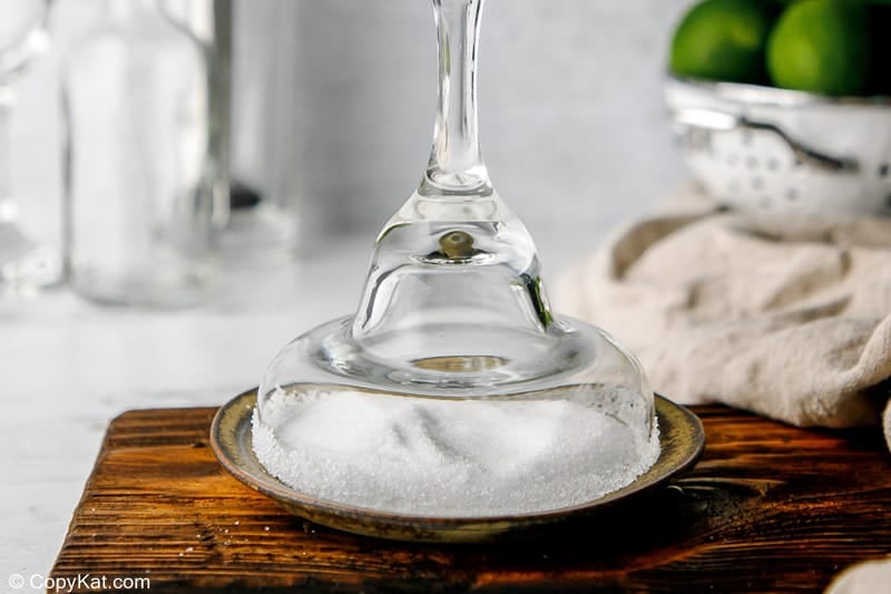 dipping the rim of a margarita glass in salt