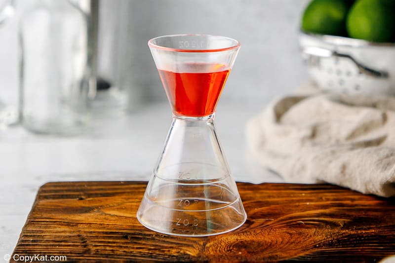 Monin watermelon syrup in a jigger