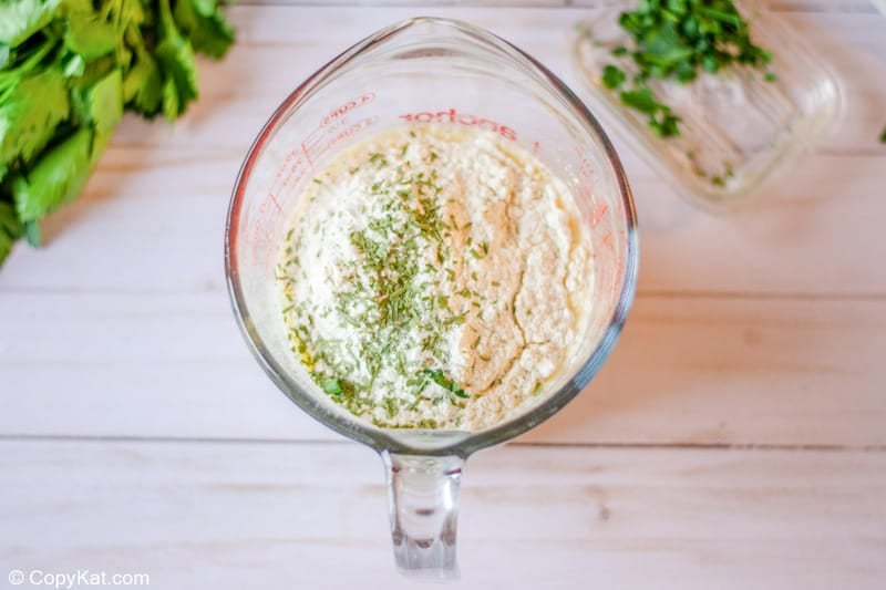 tarragon chicken casserole dry ingredients in a measuring cup.