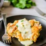 a serving of tarragon chicken casserole topped with sauce on a plate.