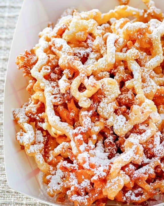 funnel cake fries in a paper serving dish