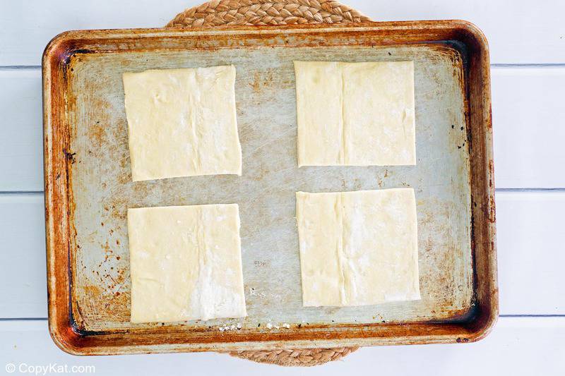 puff pastry squares on a baking sheet
