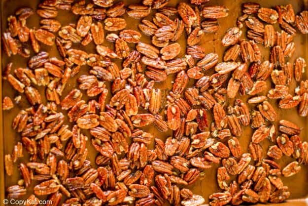 spiced pecans on a baking sheet before roasting