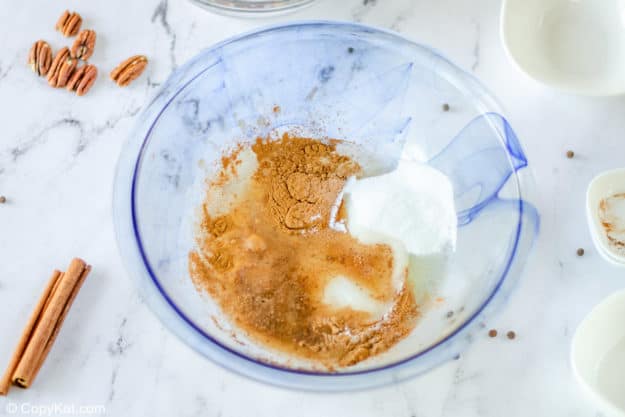 ingredients for spiced pecans coating in a bowl
