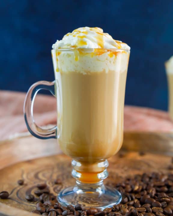 homemade Starbucks caramel macchiato on a wood tray.