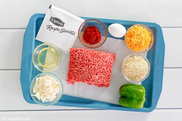 stuffed meatloaf with gravy ingredients on a tray